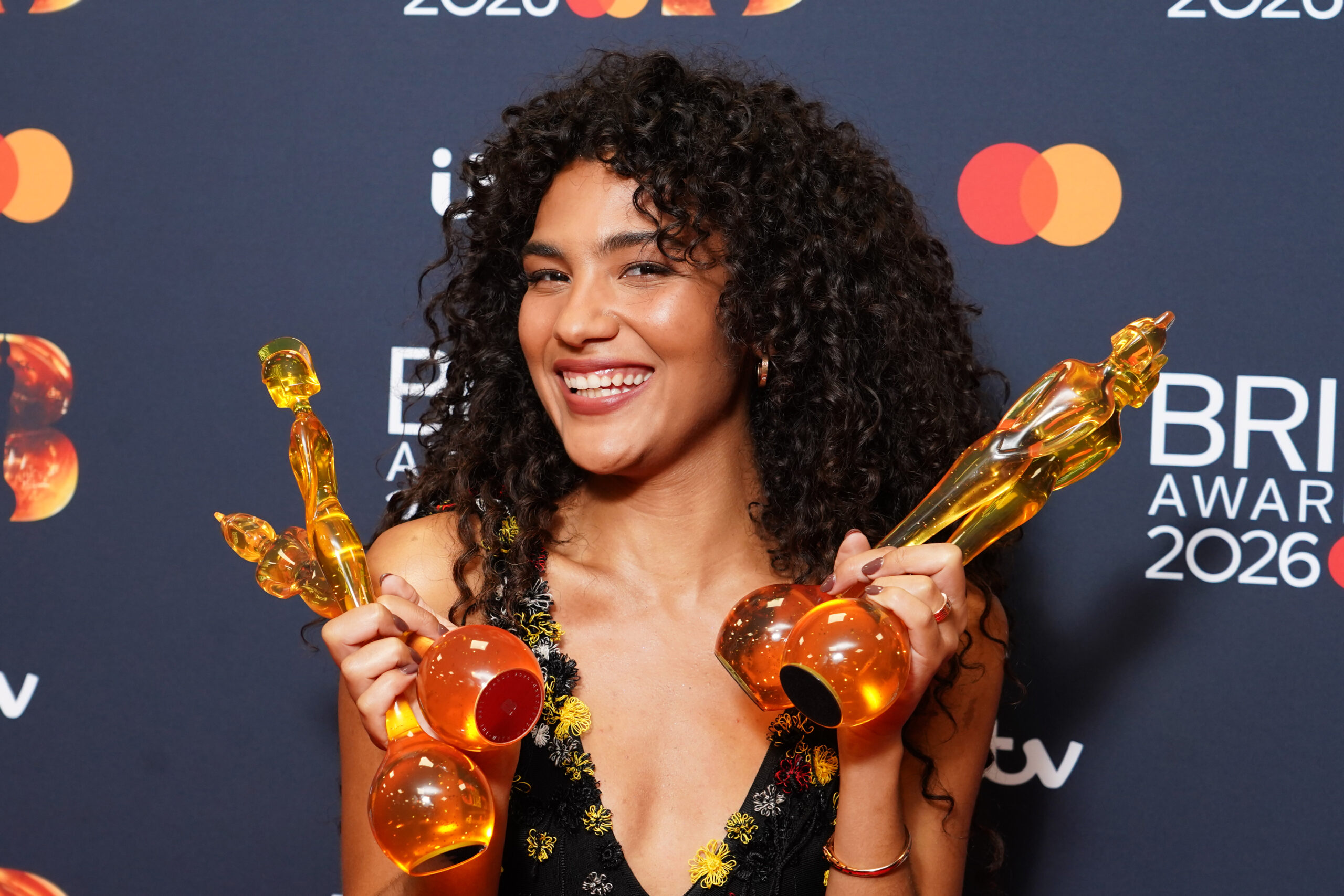 Olivia Dean with her four Brit Award